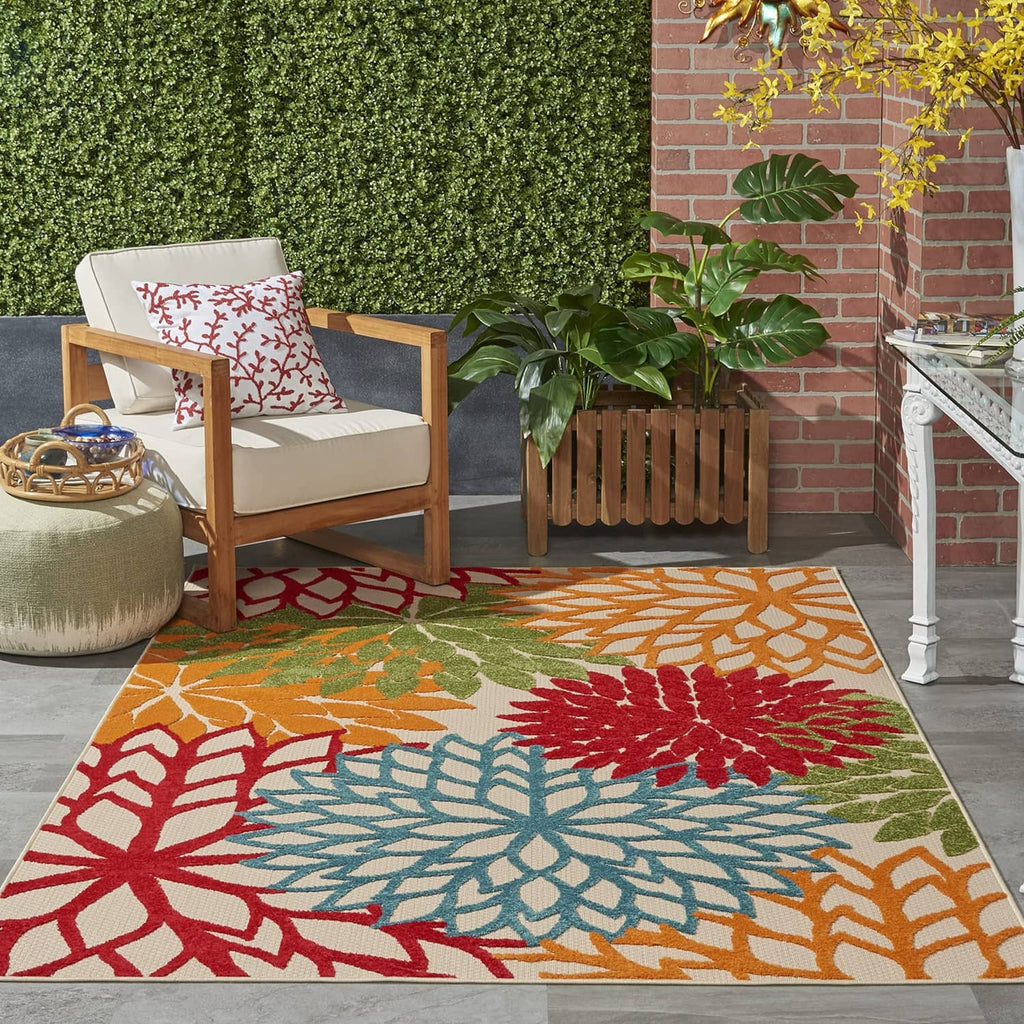 Tropical area rug with multicolor floral pattern in red, teal, orange, and green