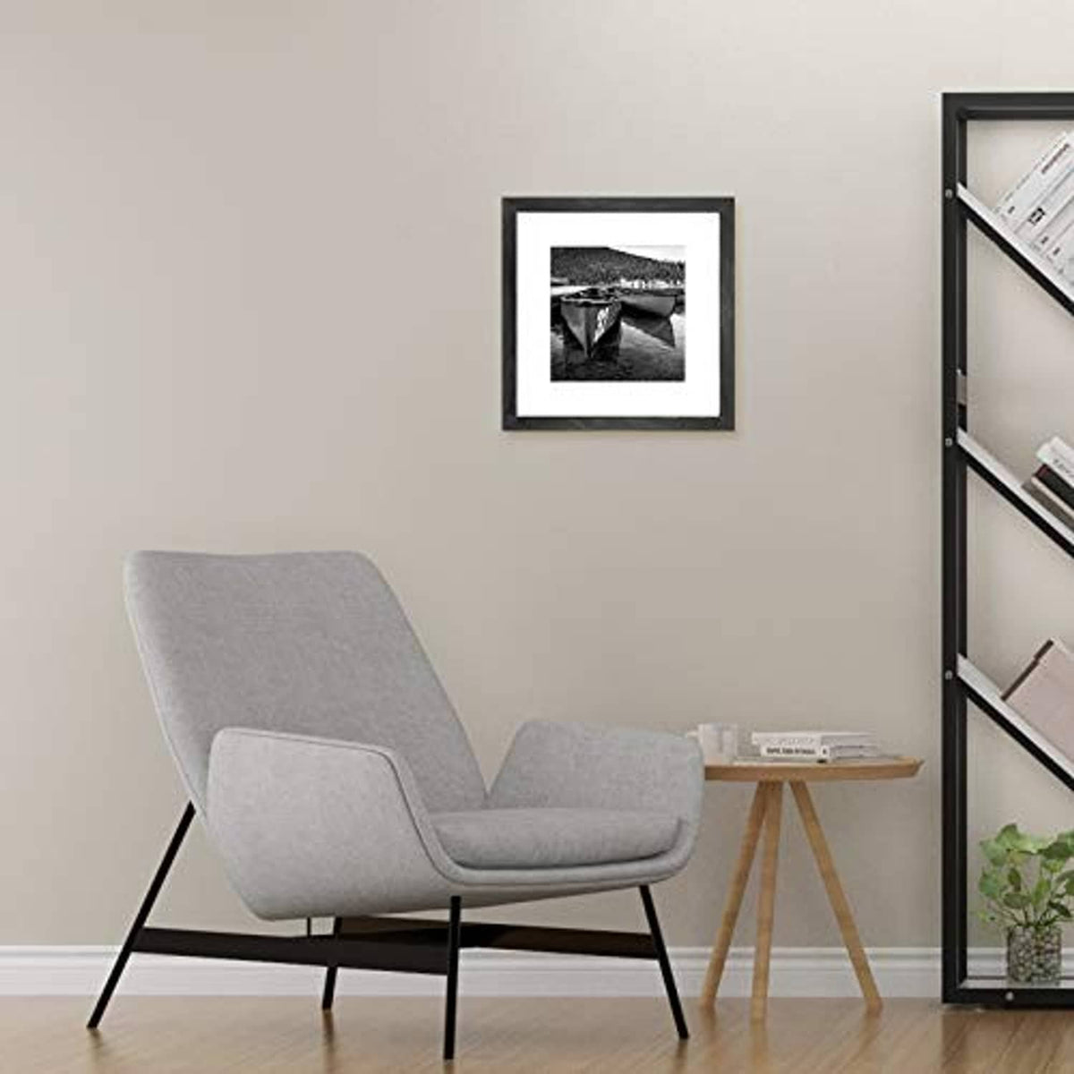 Black picture frame with white mat displaying a small black-and-white photo.