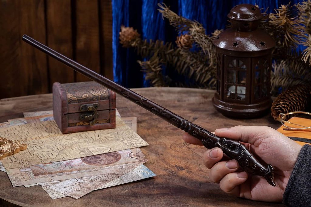 Handheld dark brown carved wooden witch wand with ornate handle and pointed tip