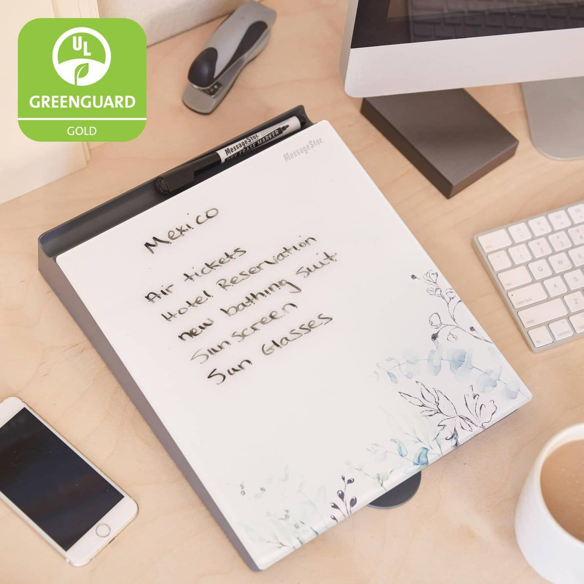 Botanical dry-erase glass memo board with handwritten message and black frame on desk