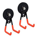 Pair of orange J-shaped magnetic garage hooks with black round bases and steel fastener