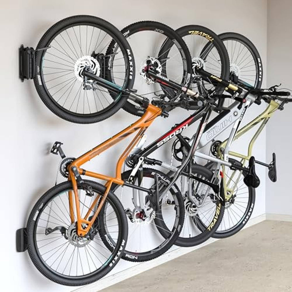 Swivel bike wall mounts holding four bicycles, black wall brackets and curved arms