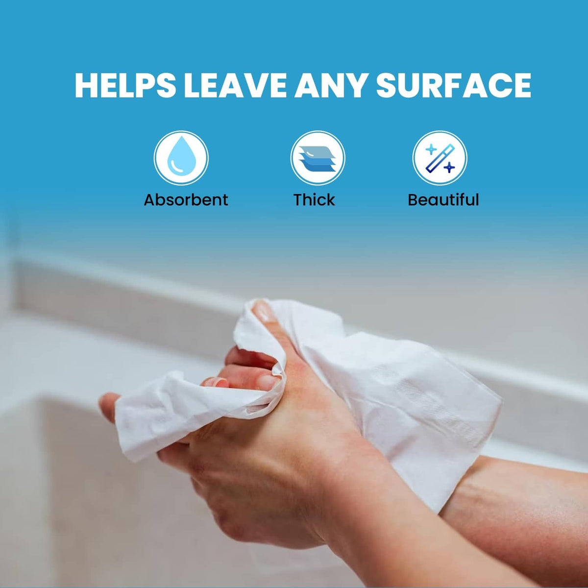 White multi-fold paper towel held over sink surface for wiping