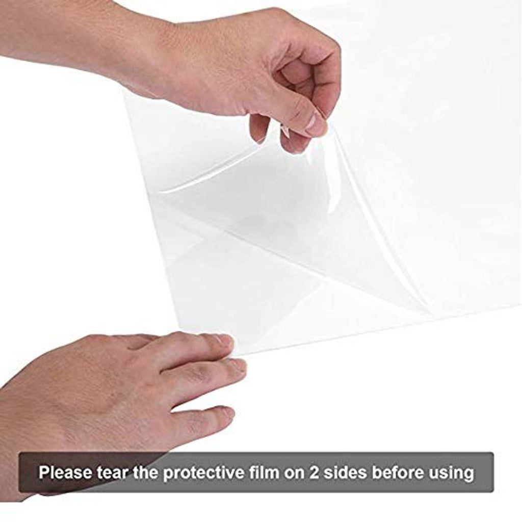 Hands peeling protective film from clear plexiglass front of a wooden picture frame
