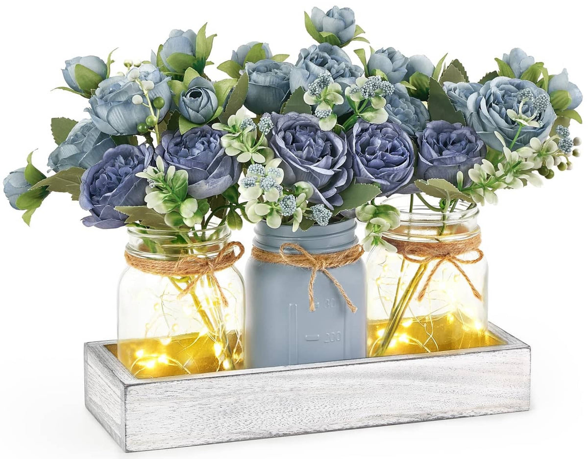 Mkono mason jar light centerpiece with blue faux roses in grey-blue jars on white tray