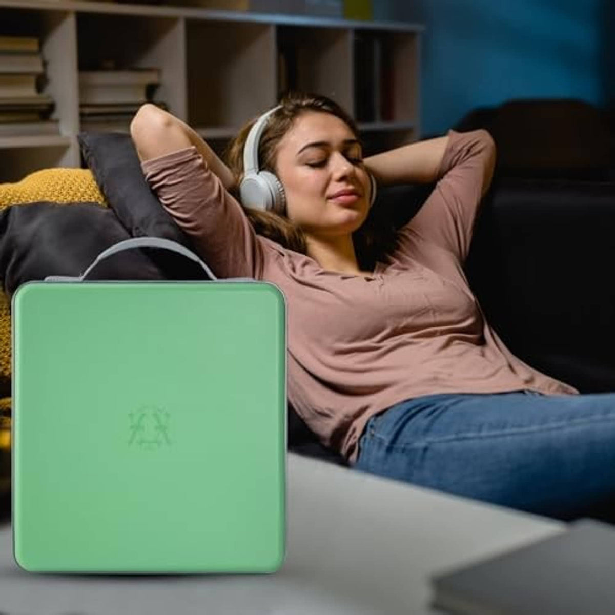 Green hard-plastic CD organizer case with handle, closed