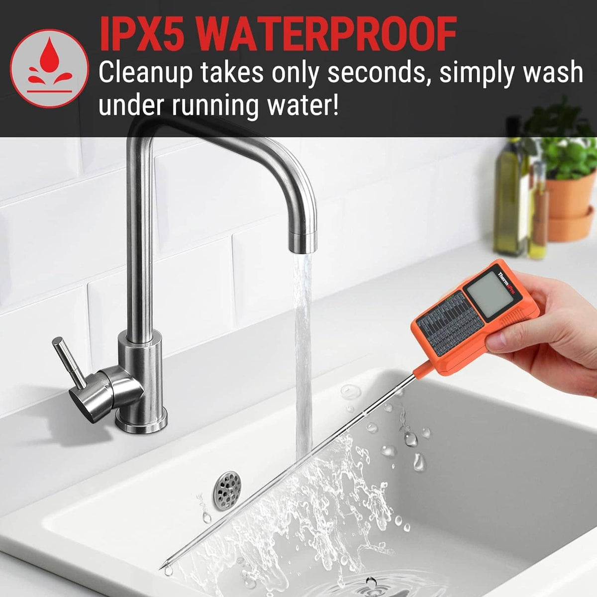 Orange waterproof digital thermometer with long probe held over a sink faucet