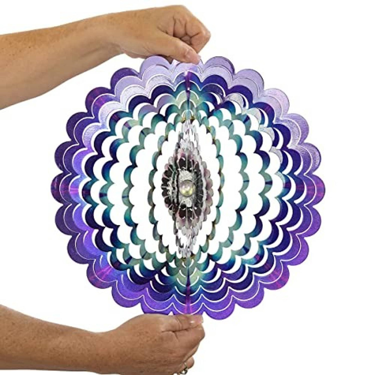 Floral wind spinner held by hands, with purple-blue layered petals and metal center