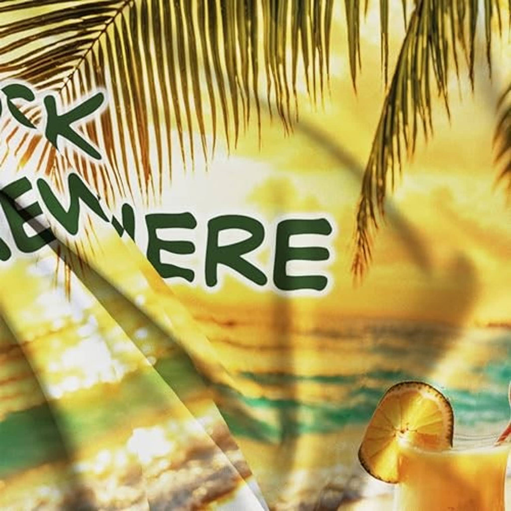 Close-up of beach parrot flag print with partial "O'Clock Somewhere" and palm leaves