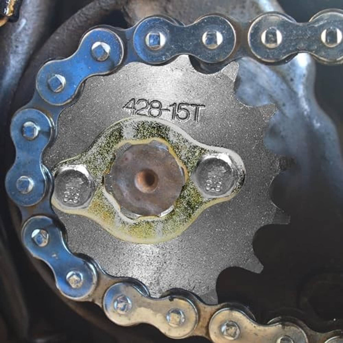 428-15T sprocket wheel with central hub hole and mounting collar ring