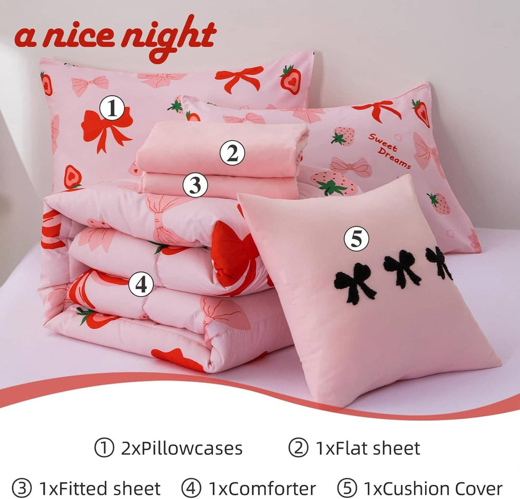 Stacked pink bedding set with bow prints, featuring pillows, flat sheet, fitted sheet, comforter