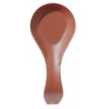 Brick-red stainless steel spoon rest with curved teardrop shape