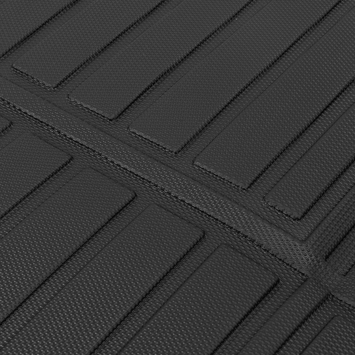 Close-up of black rubber floor mat with rectangular tread channels
