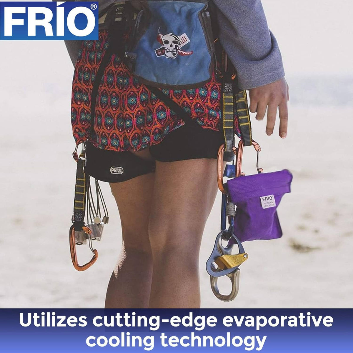 Purple FRIO cooling wallet pouch clipped to a belt with carabiner-style straps