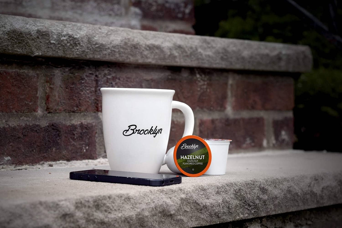 White mug with small hazelnut coffee pod cup