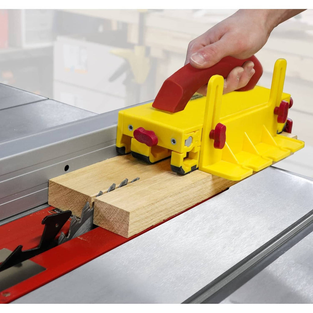 Yellow-and-maroon push block with raised fence, clamps and red rubber pads for routing