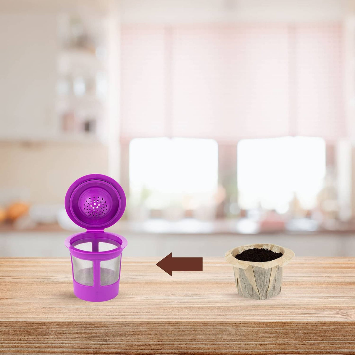 Paper coffee filter cup filled with dark grounds beside a purple brewing cup