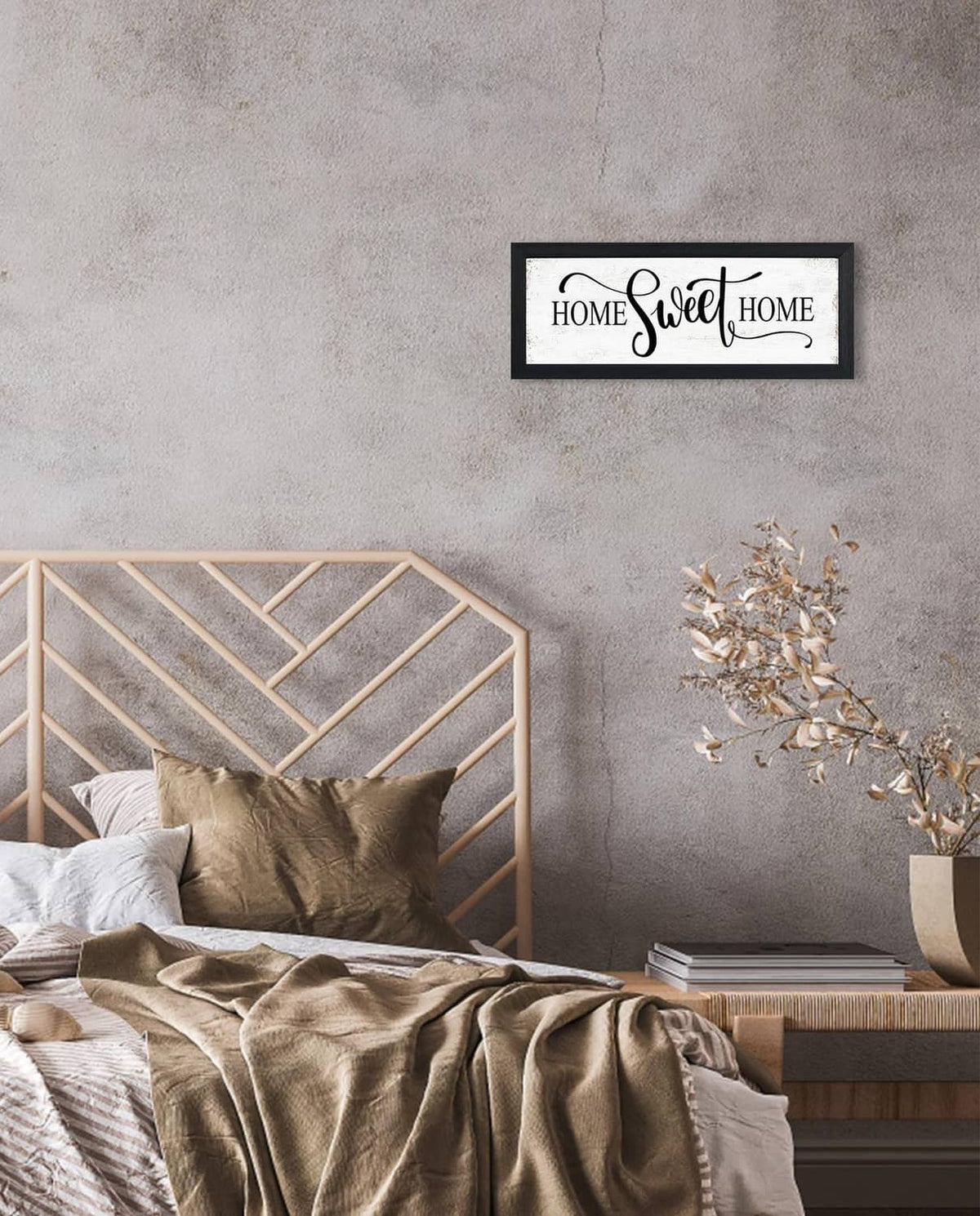 Black-framed wall sign with “HOME Sweet HOME” script lettering on white panel