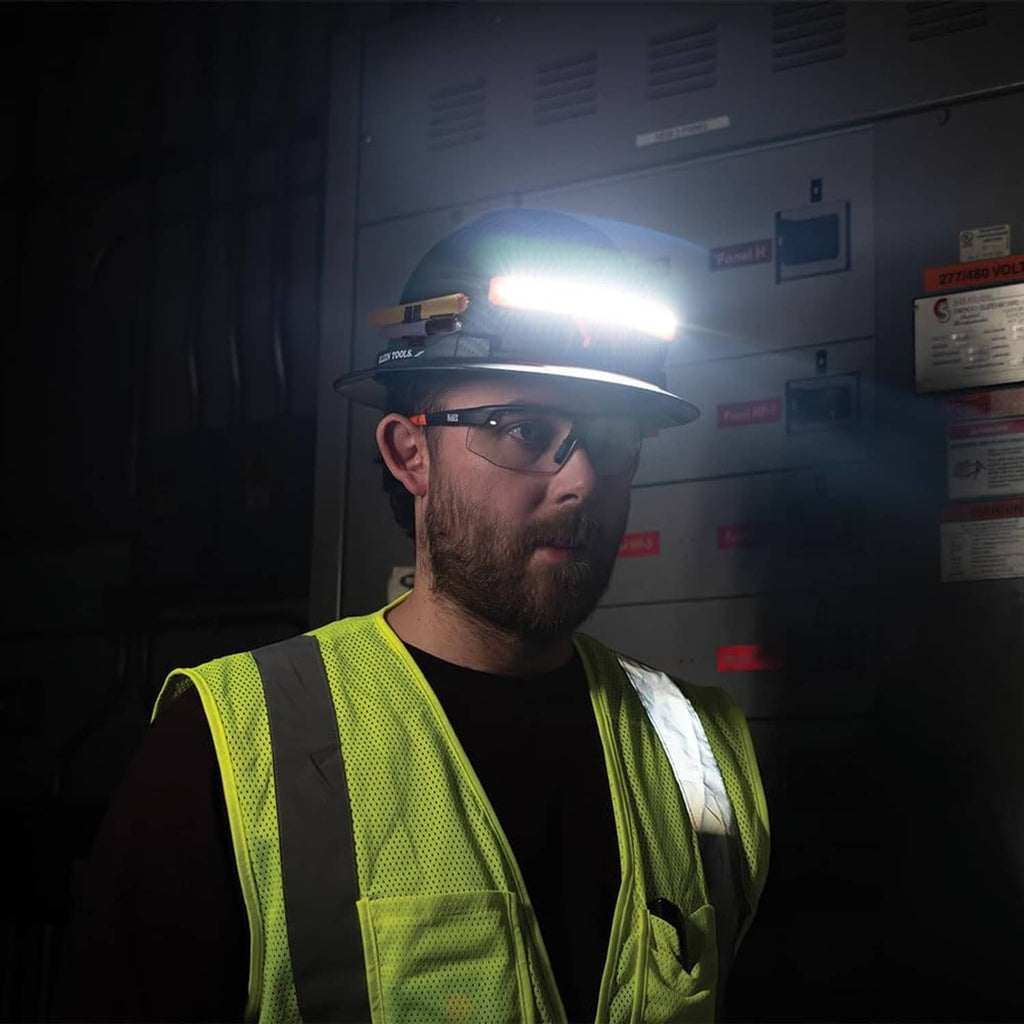 Worker wearing rechargeable LED headlamp with strong white beam overhead
