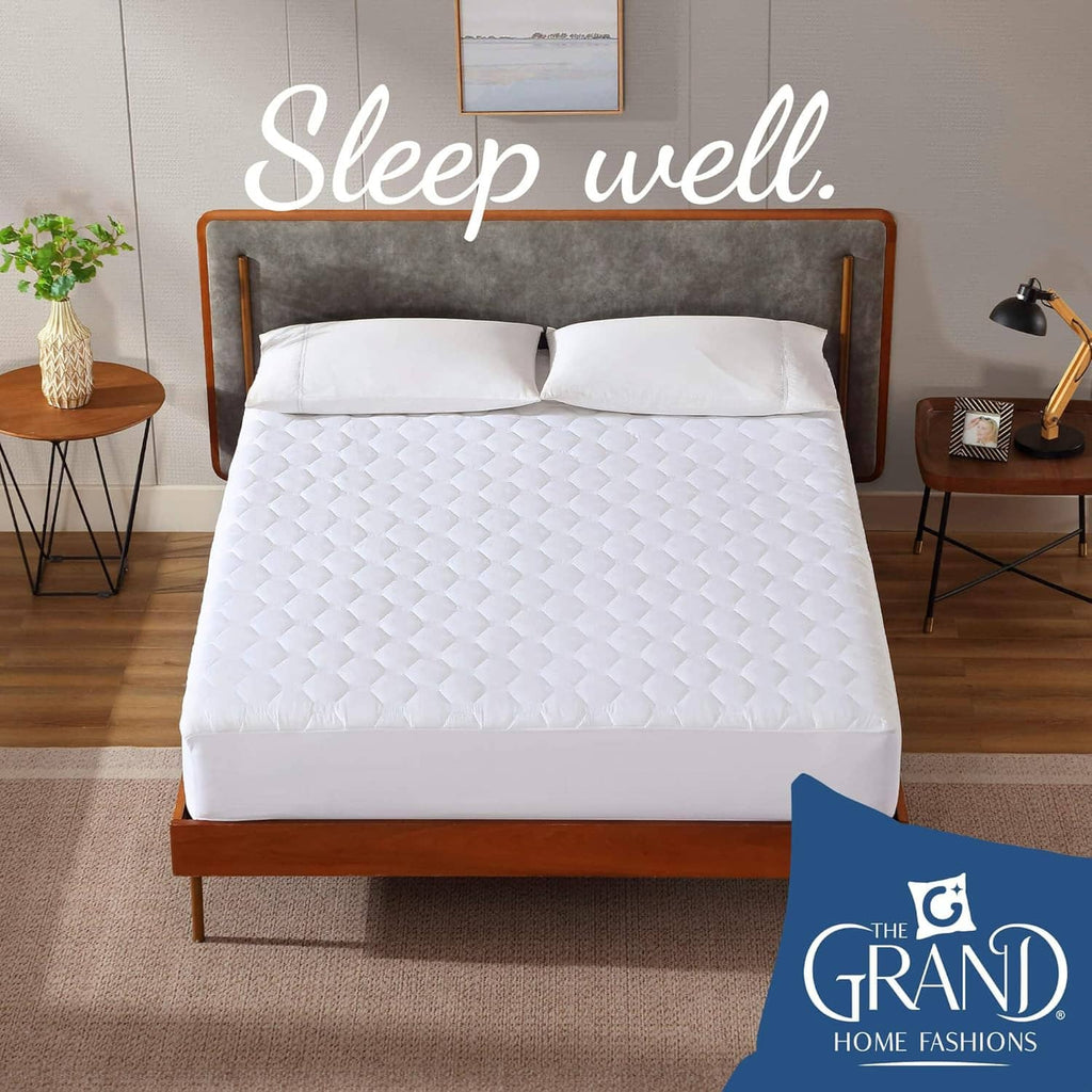 White quilted mattress pad on queen bed, smooth top layer