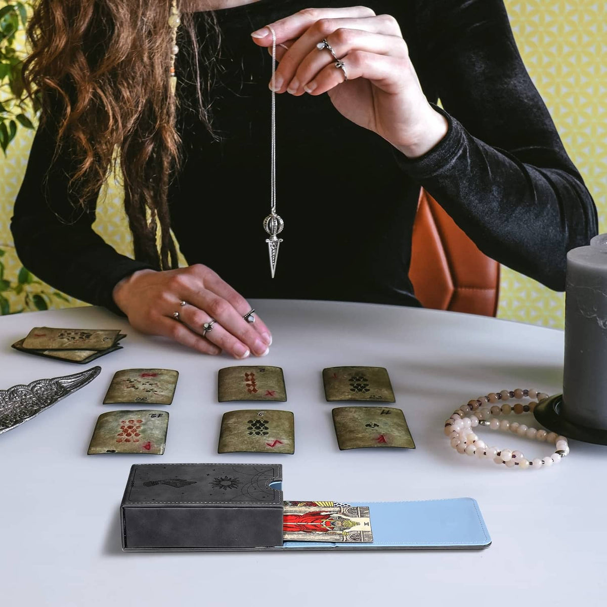 Grey tarot card case with open blue interior used to hold and organize cards
