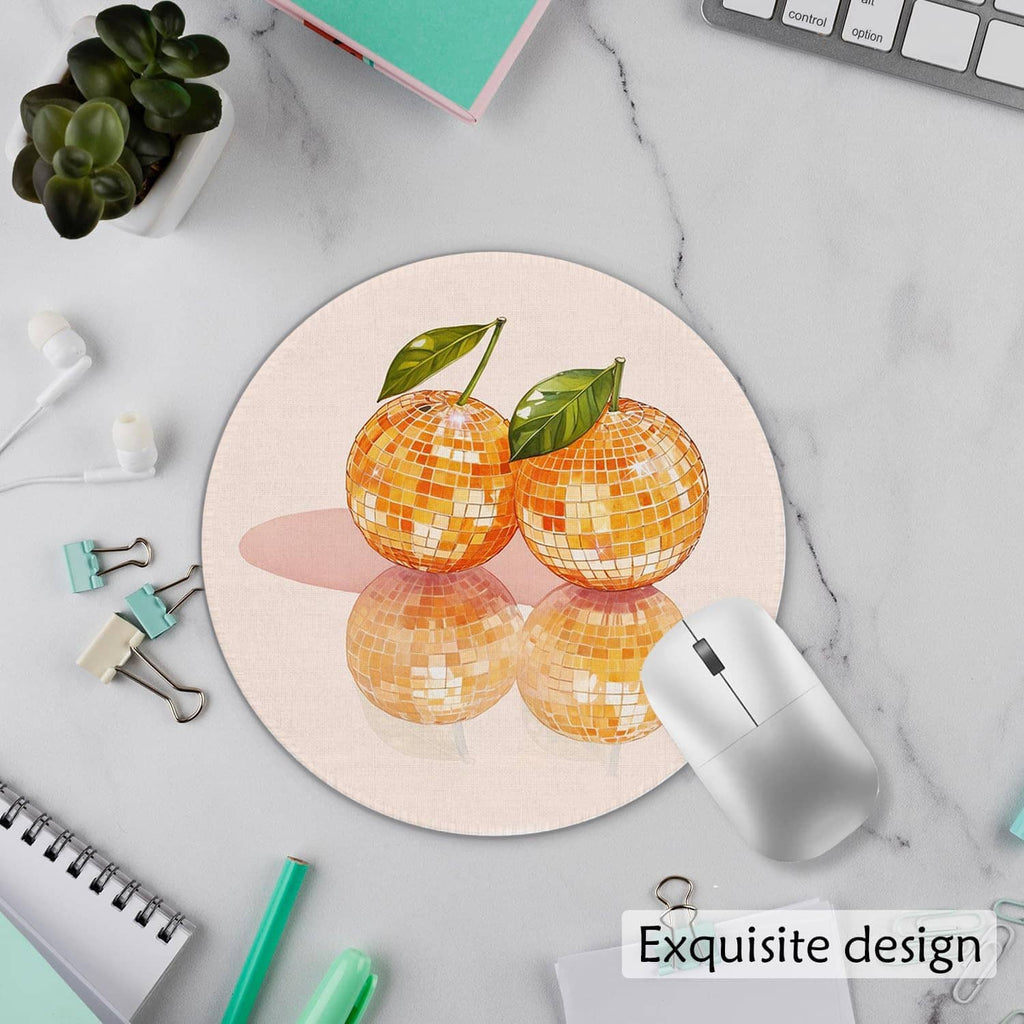 Round mouse pad with orange disco ball motif and green leaves with reflections