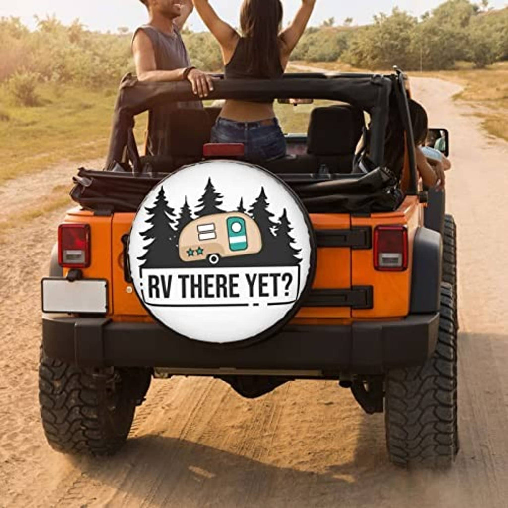 Rear view of an RV with a white round spare tire cover, camper and trees, “RV THERE YET?”
