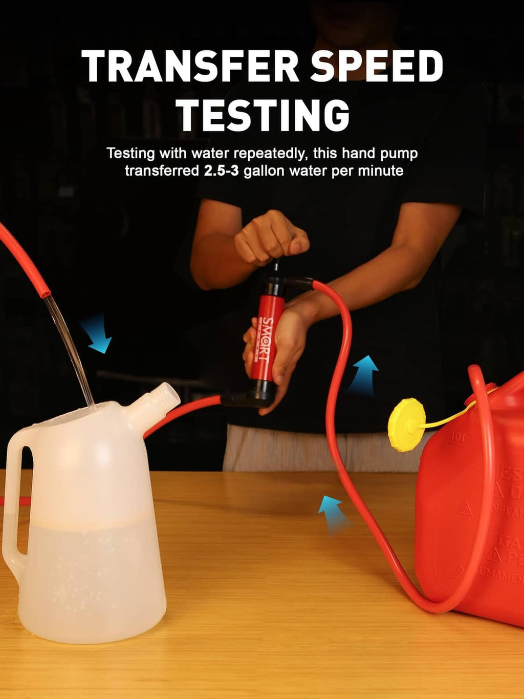 Red hand transfer pump with hose attached to a water container