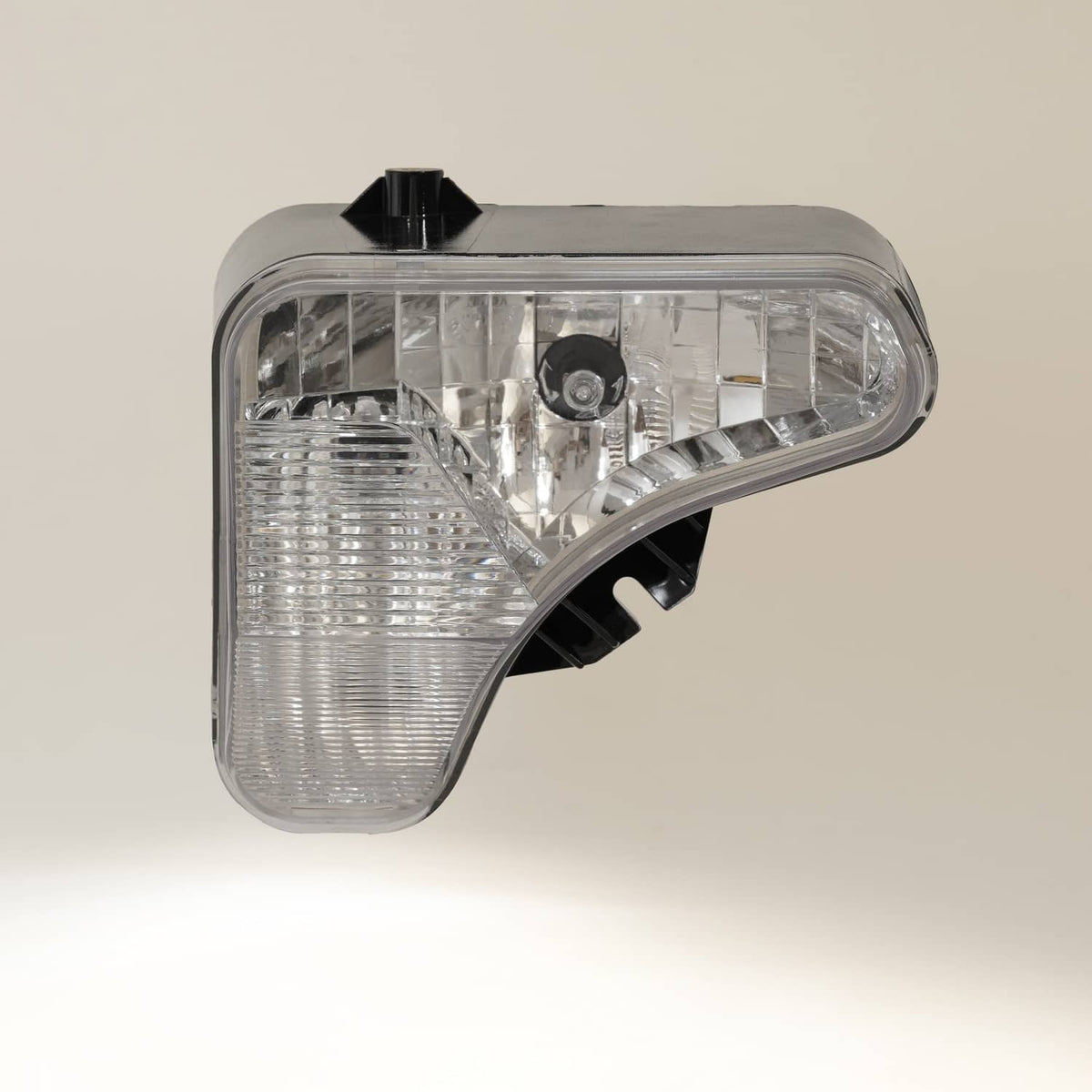 Right headlight lamp with clear lens, reflector, and black mounting tabs