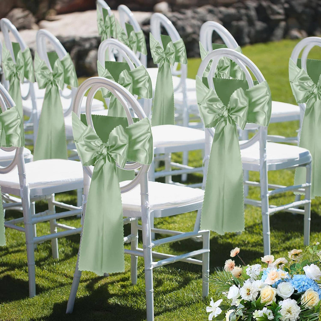 Sage green satin chair cover sashes tied in bows on outdoor white chairs