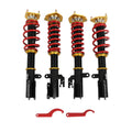 Coilover suspension strut set with red coil springs, black shocks, gold top mounts
