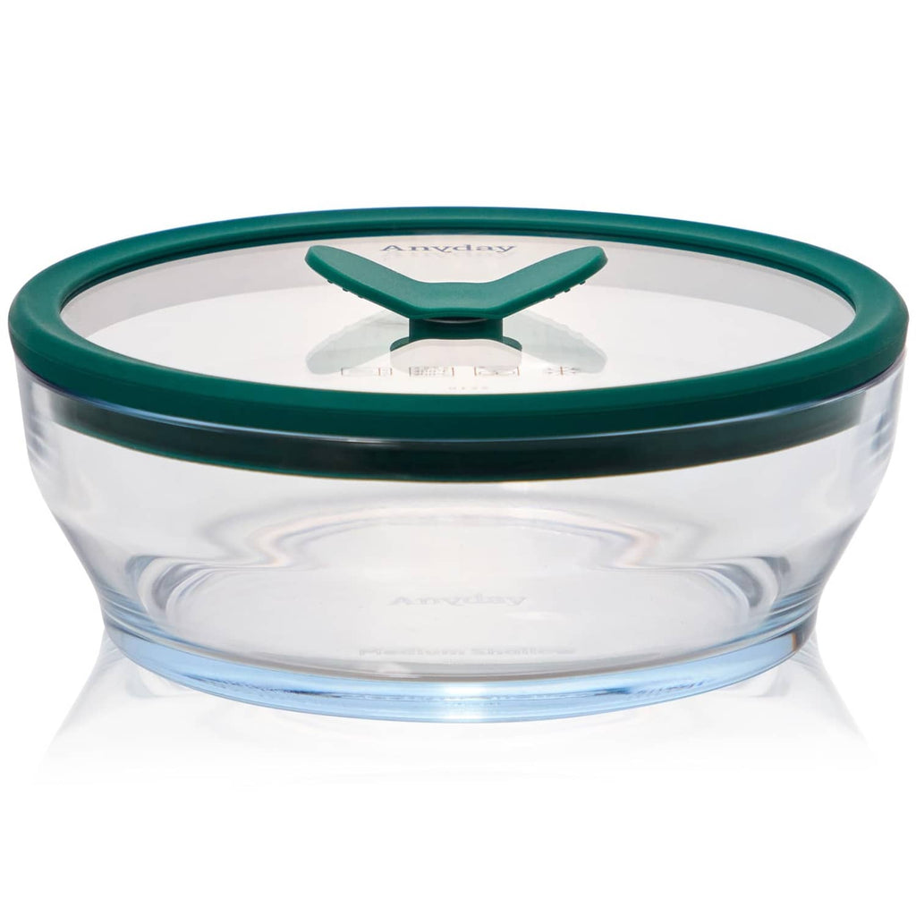Clear round glass food storage container with dark green silicone lid, medium size