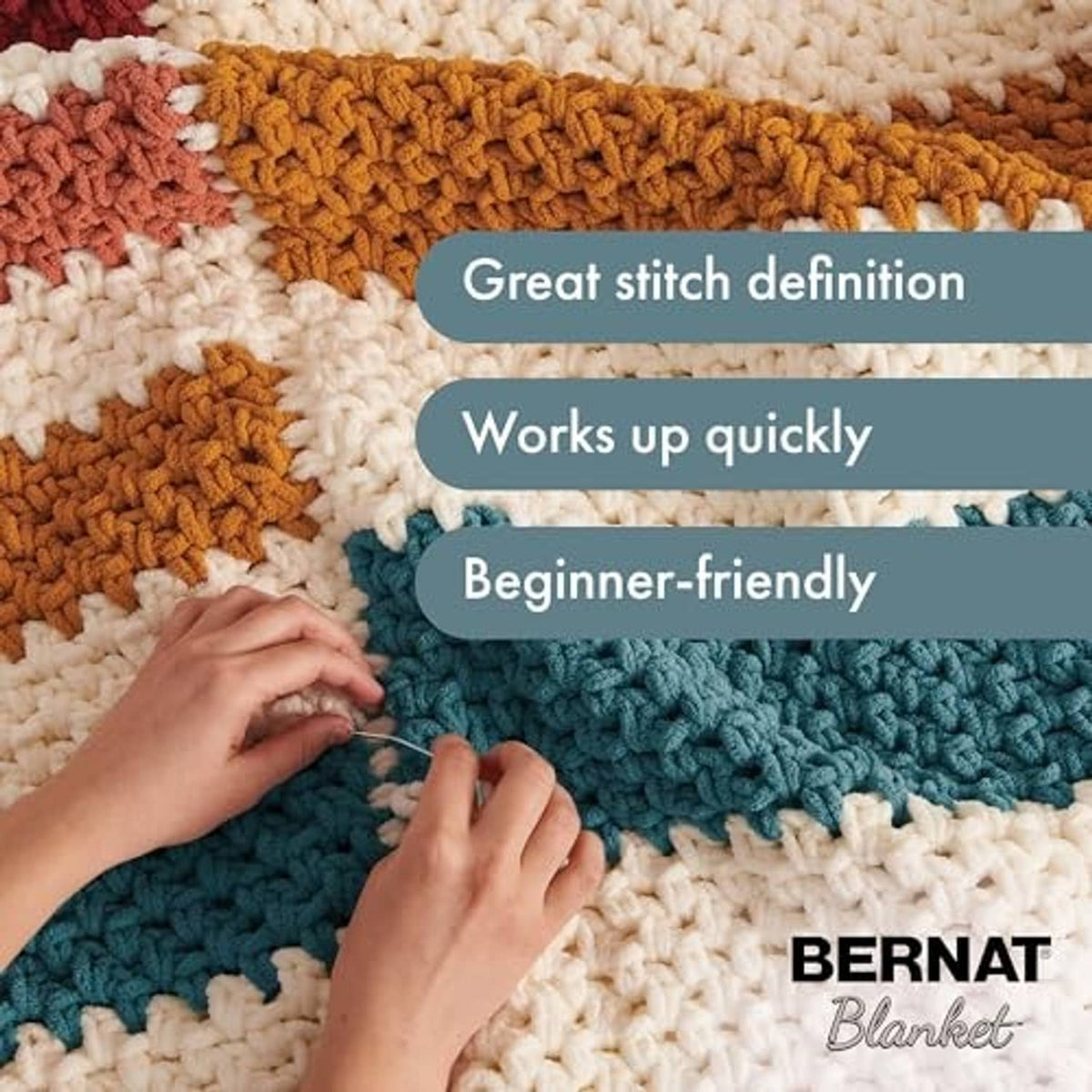 Hands crocheting on striped blanket swatches with super bulky yarn and Bernat branding