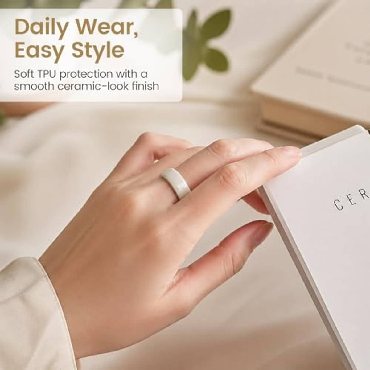 Soft TPU ring cover on a person’s finger in light pink/white, size 8.