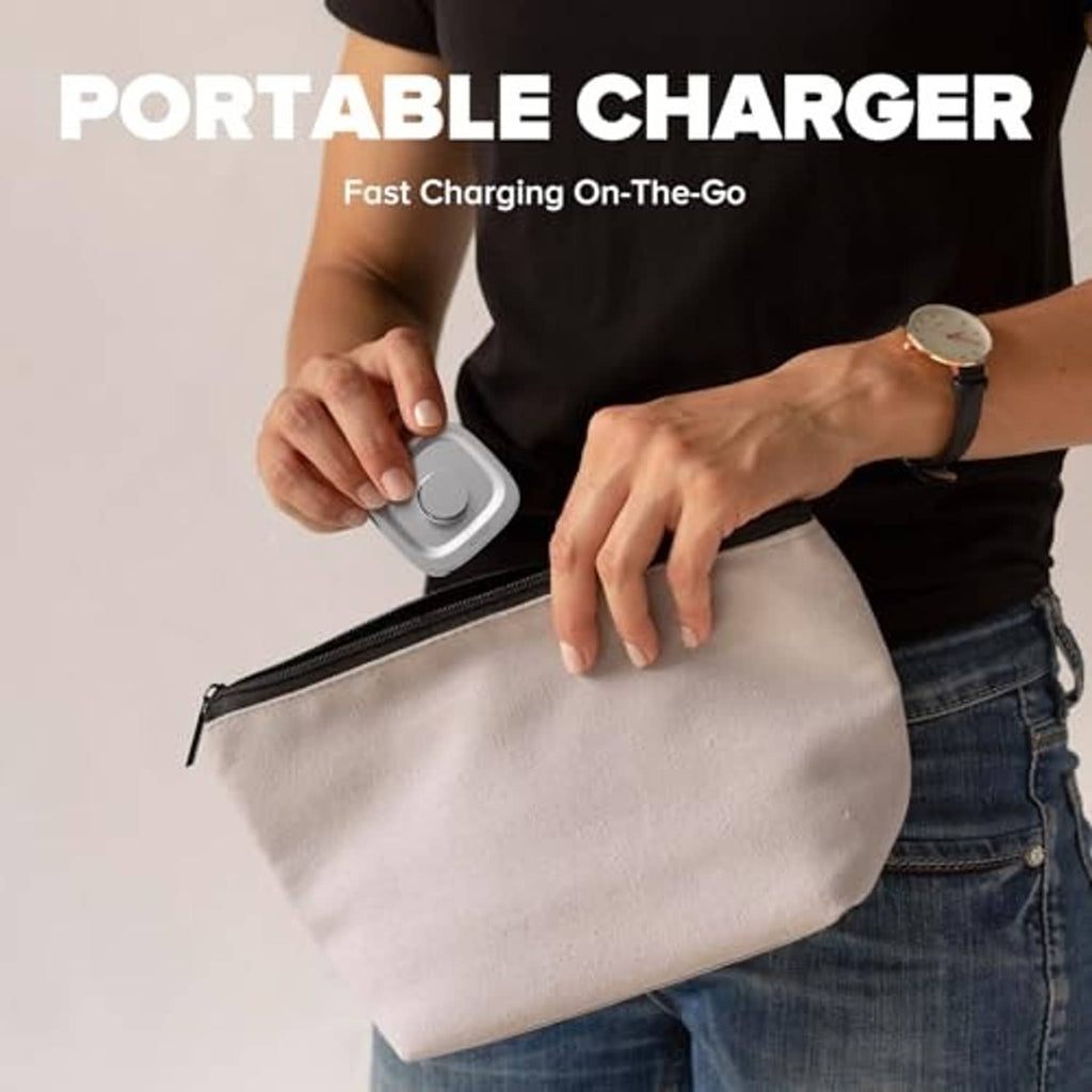 Portable light silver ring charger in hand, with cable and compact dock