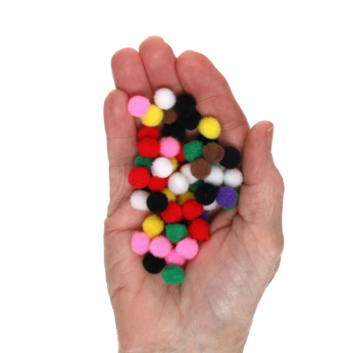 Hand holding mixed-color cotton pom pom balls, small fuzzy craft pieces