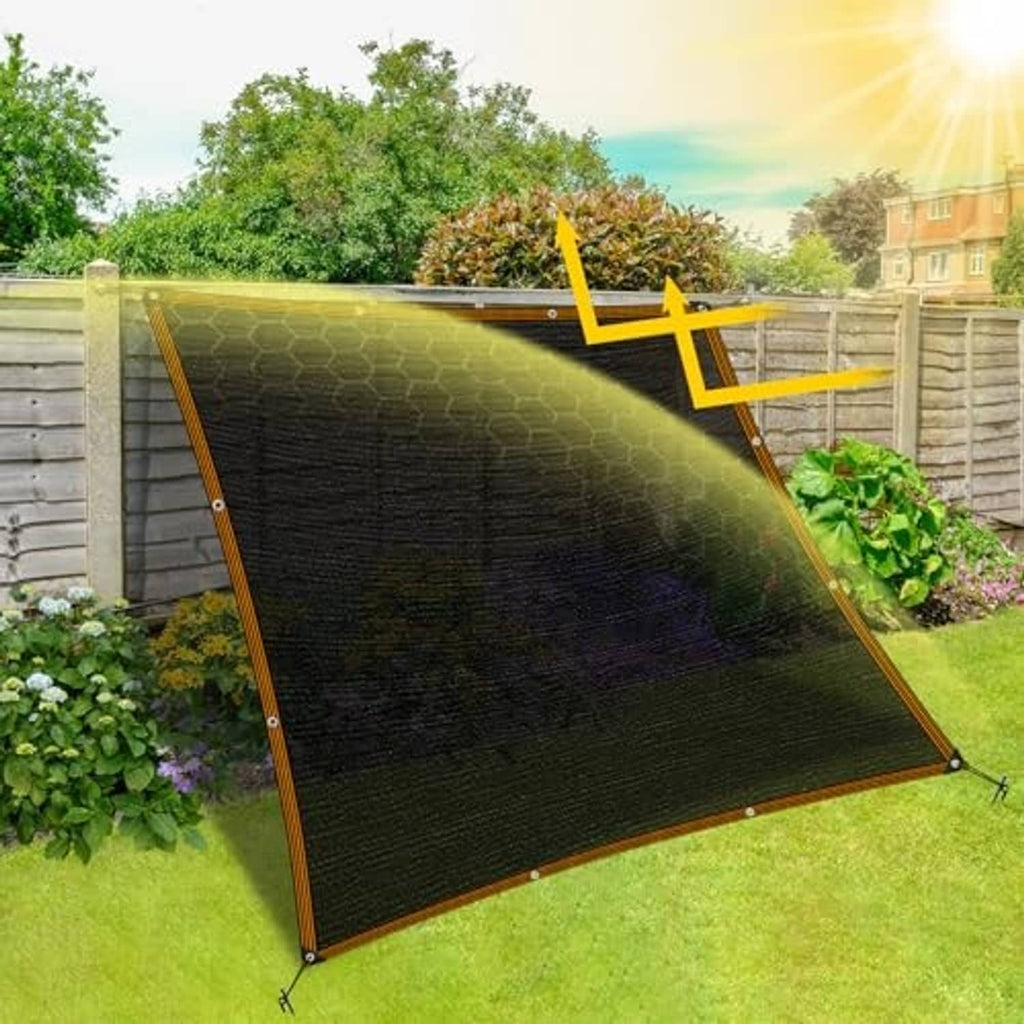 Black mesh shade cloth tarp on a slanted frame with grommet corners and yellow binding