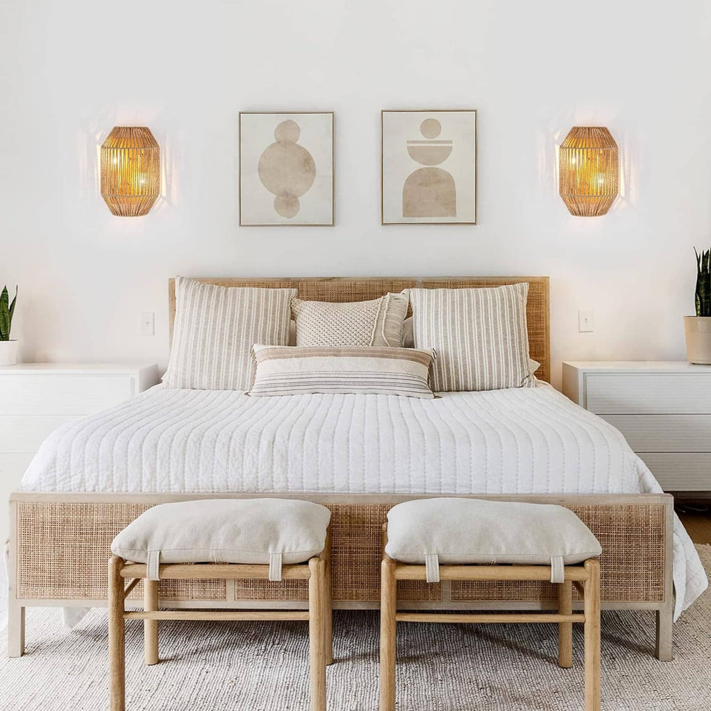 Set of 2 woven rattan wall sconces with glowing light through the lattice shades