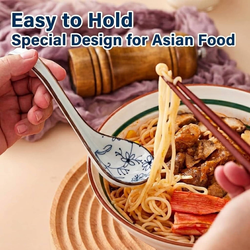 Ceramic Asian soup spoon with blue-and-white porcelain scoop held over noodle bowl