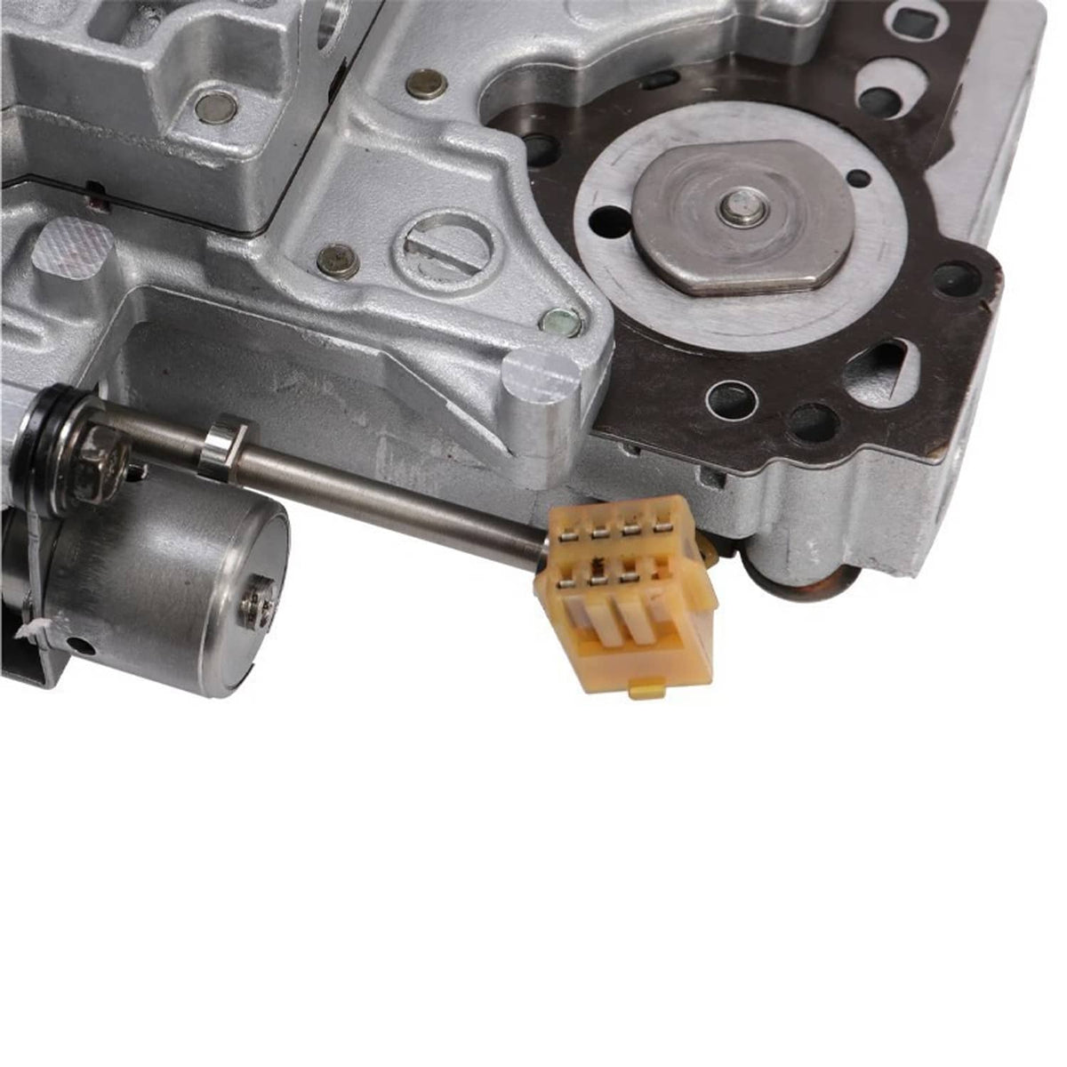 Transmission valve body solenoid area with circular metal cover and multi-pin connector
