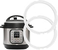 White silicone sealing gasket ring for pressure cooker lid, shown with cooker base