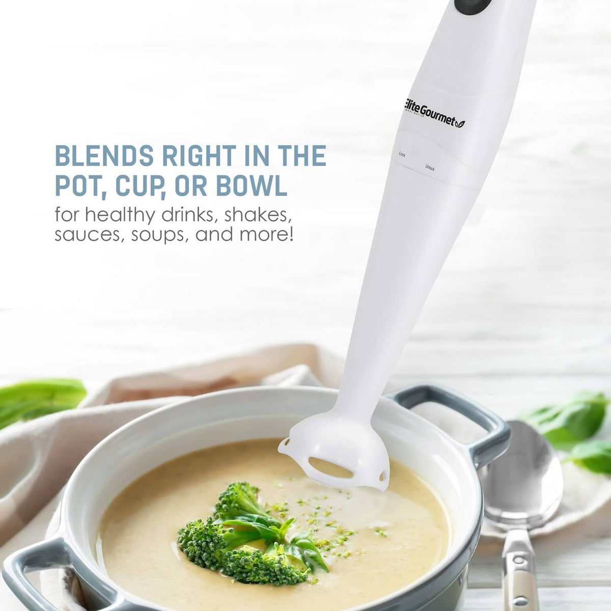 White immersion blender with detachable shaft blending inside a pot