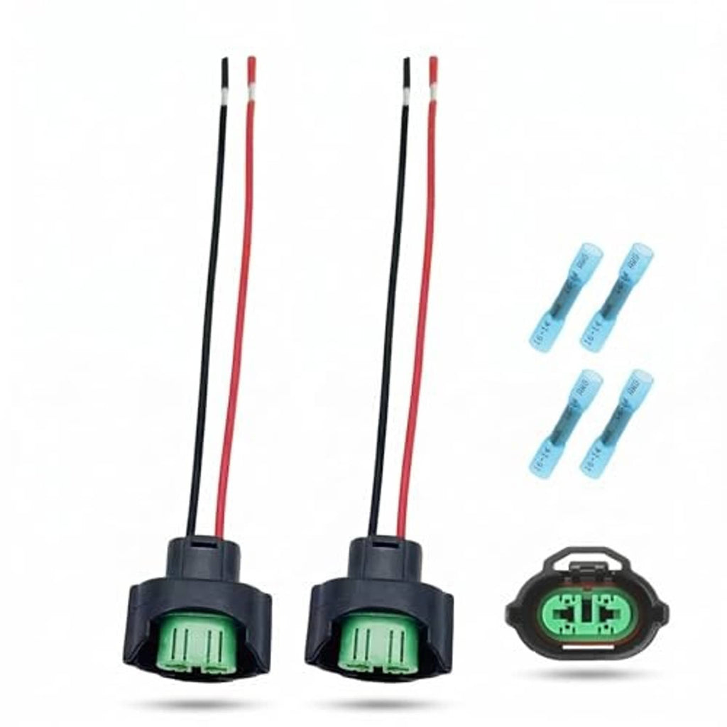 Two wiring harness connectors with red and black leads, green terminal inserts
