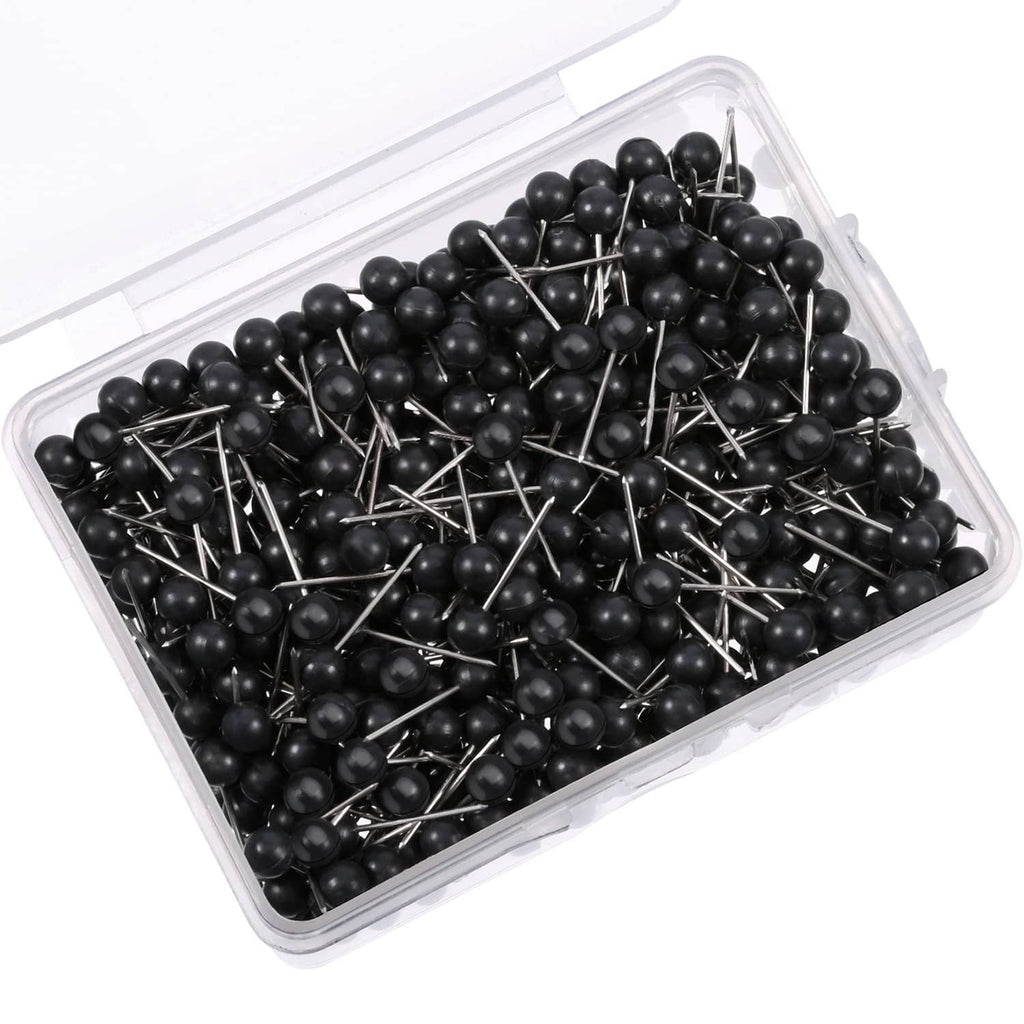 Black push pins with round heads and metal tips in a clear plastic container.