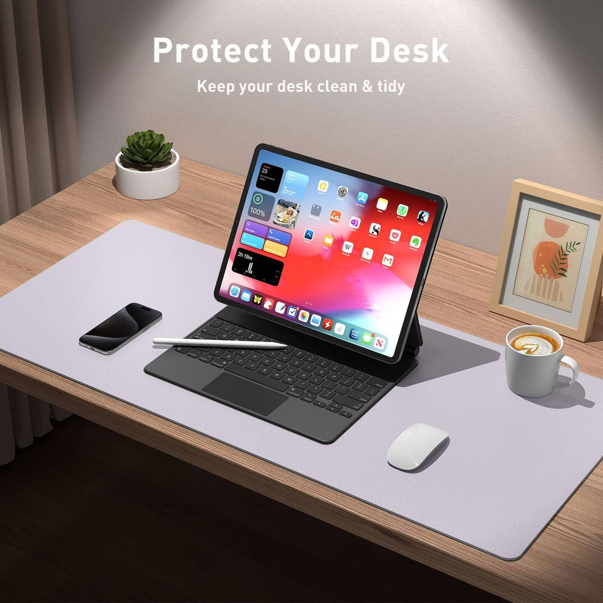 Lavender PU leather desk pad protector under a laptop and mouse on a wooden desk