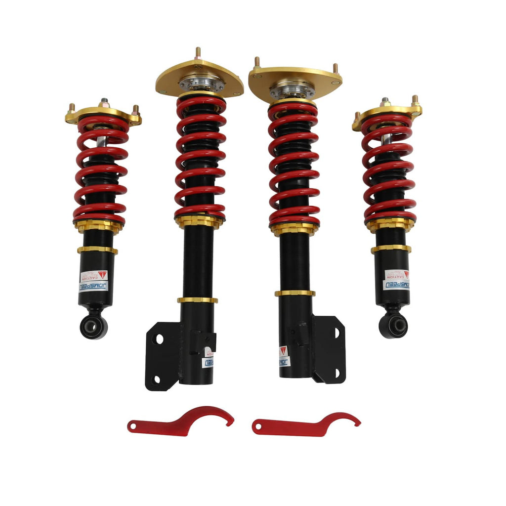 Coilover strut set with red coil springs, black dampers, gold plates, and red C-wrench
