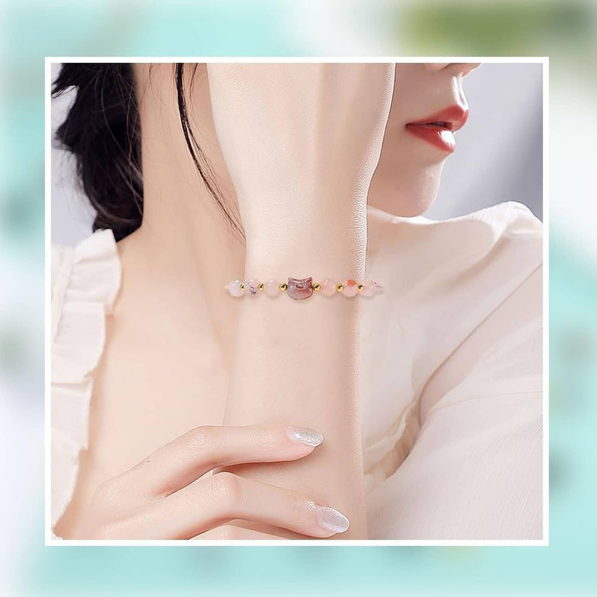 Cat-glass-bead necklace on a model, with small colorful beads across the collarbone.