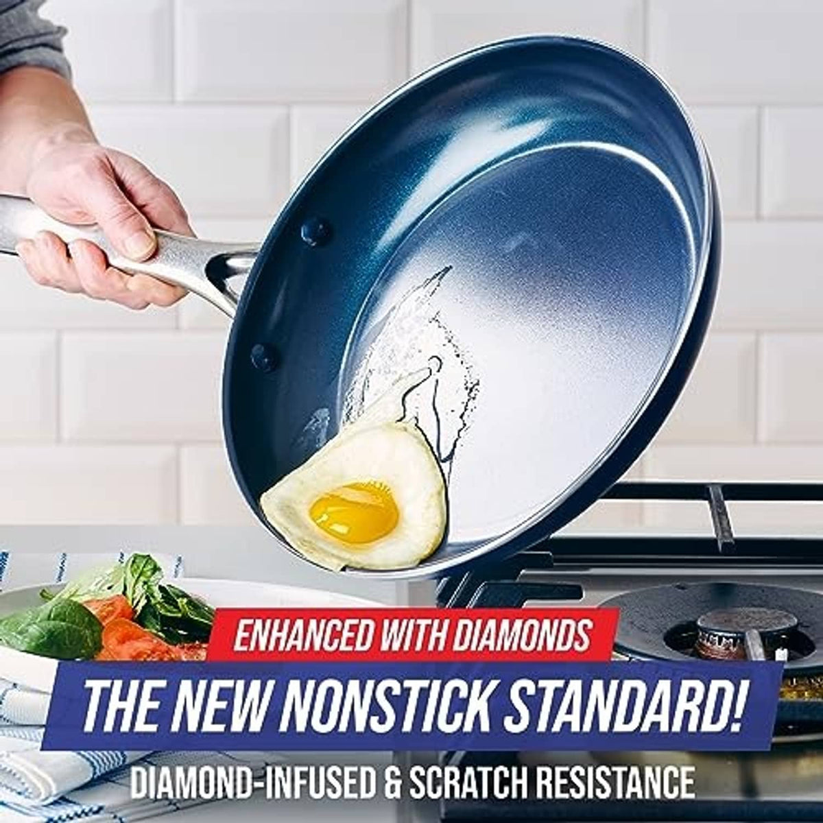 Blue nonstick frying pan skillet with speckled interior, silver handle, and egg cooking inside