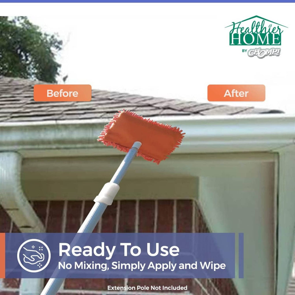 Orange scrubbing mop pad on extension pole cleaning roof edge and gutter area