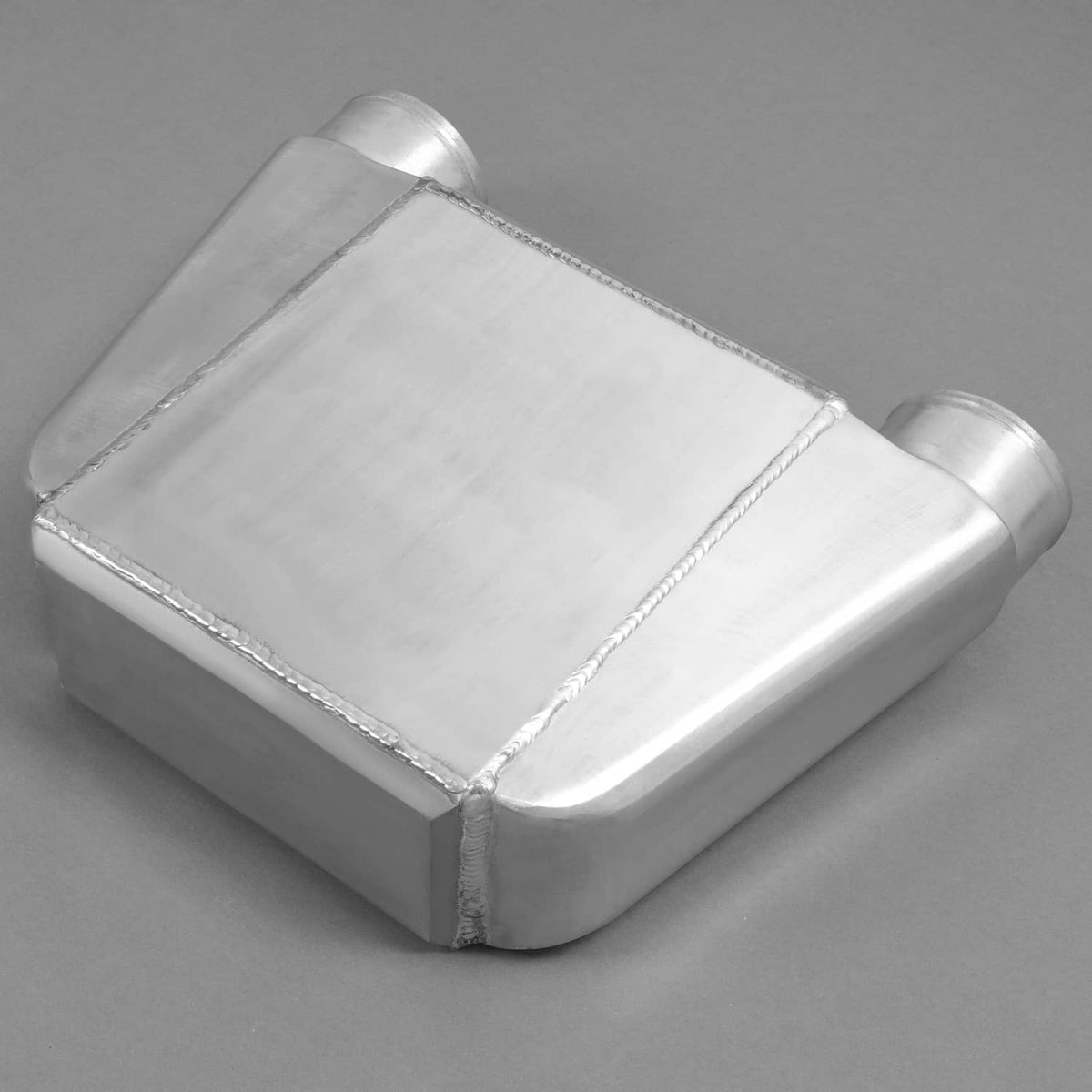 Aluminum water intercooler with rounded corners, welded seams, and outlet tube ends